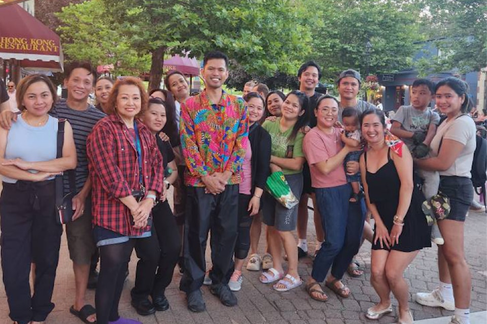 Jyn San Miguel (eighth from left) and fellow Filipino-Canadians at his guest performance at REVY.Live Outside in Grizzly Plaza on Monday, Aug. 11.