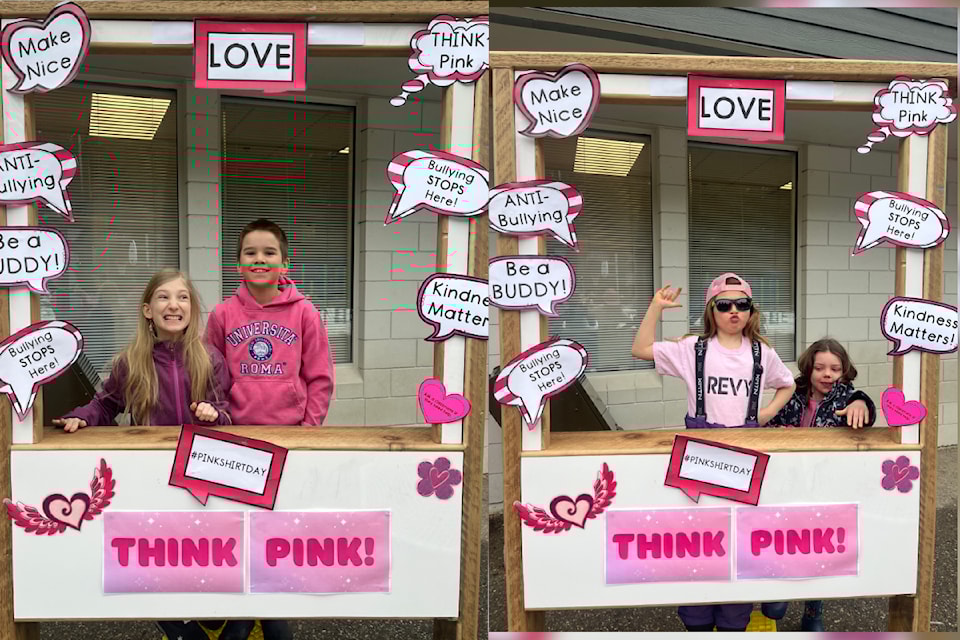 Arrow Heights Elementary School students sport pink at the "think pink" photo booth for Pink Shirt Day Wednesday, Feb. 26.