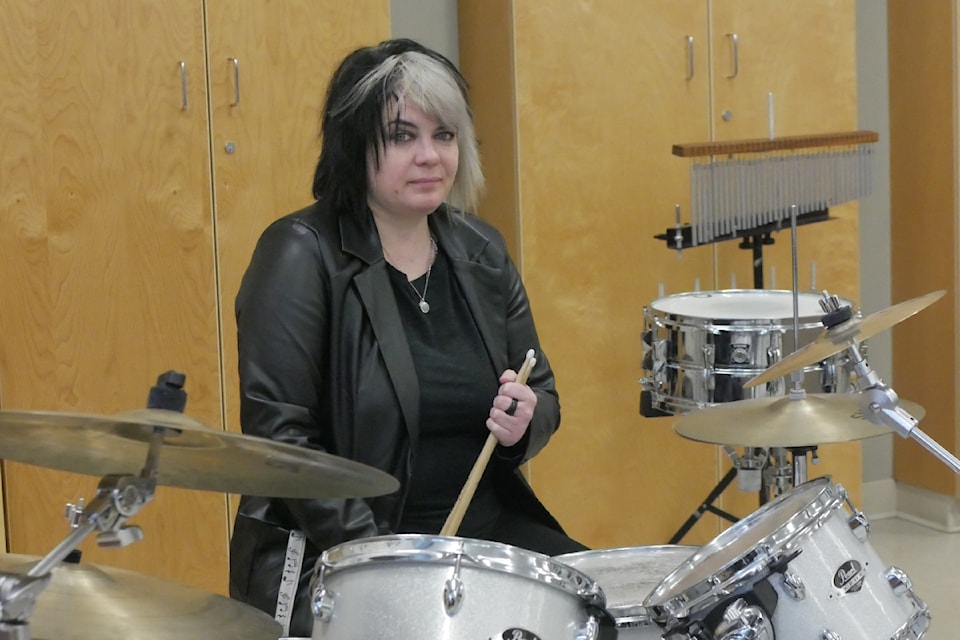 Tessa Davis, a music teacher at Revelstoke Secondary School, in the band room Thursday, Jan. 16, with the drums that Curtis Magarian played when he was her student.