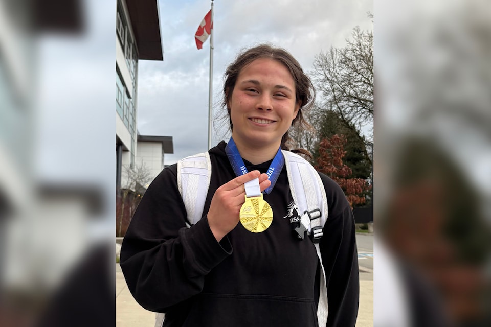 Ashley Booth, standing outside New Westminster Secondary School, sports her gold medal from the BC Wrestling Association Provincial Club Championships, hosted in Vancouver during March.