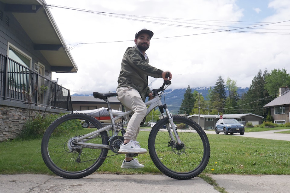 Dipendra Thapa with his new bike outside his Columbia Park home Saturday, May 17.