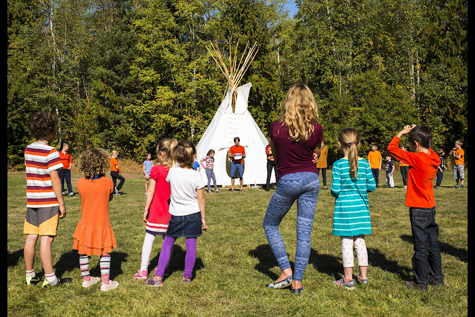 Ecole des Glaciers students Cormac Clowater (left) and Morgan Stefura (right) colour in birds during an exercise to commemorate Orange Shirt Day last Friday. The day is held in the spirit of reconciliation and recognizes the harm residential schools caused to the self-esteem and well-being of children. ~ Photo Marissa Tiel