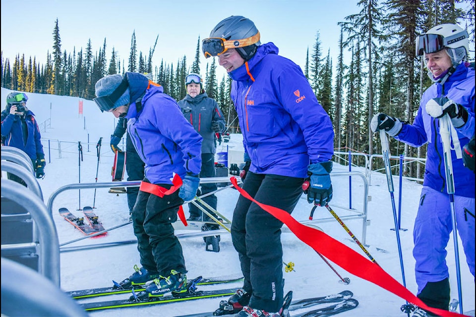 Christopher Nicolson from Canada West Ski Areas Association (centre) skis through the ribbon for the opening of the Stellar Chair. See story and more photos on page 13. (Liam Harrap - Revelstoke Review)