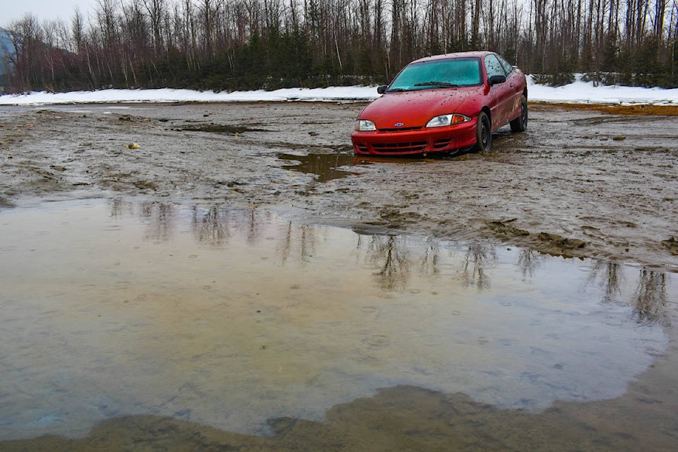 Oil leaks from a car abandoned on the banks of the Columbia River near the Highway 1 bridge into Revelstoke. (Liam Harrap/Revelstoke Review)
