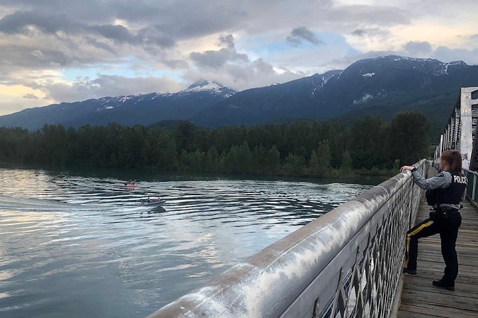 As of 8:05 p.m. July 12 the Big Eddy Bridge in Revelstoke, B.C. is closed to traffic. Three boats including at least one from Revelstoke Search and Rescue are on the water in the area and appear to be searching. (Liam Harrap/Revelstoke Review)