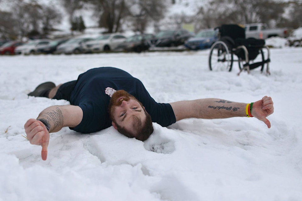 Cody Petrone, a lived-experience ambassador for CRIS, made a snow angel in Kelowna on Jan. 1, as a part of the CRIS Polar Bear Challenge. (Phil McLachlan - Capital News)