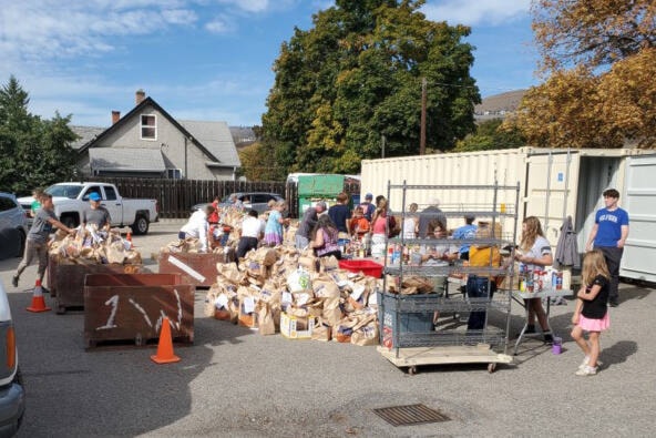 Volunteers sort through thousands of bags non-perishables donated during the Thanksgiving Food Drive Sept. 25, which collected 37,800 pounds of food for the Salvation Army Food Bank. (Contributed)