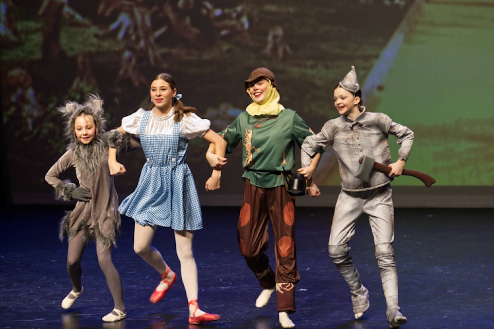 Skye Cawthorne as Toto, Loren Morabito as Dorothy, Emily Hunt as The Scarecrow and Violet Ryga as The Tin Man skip off down the yellow brick road in The STUDIO’s ballet The Wizard of Oz.