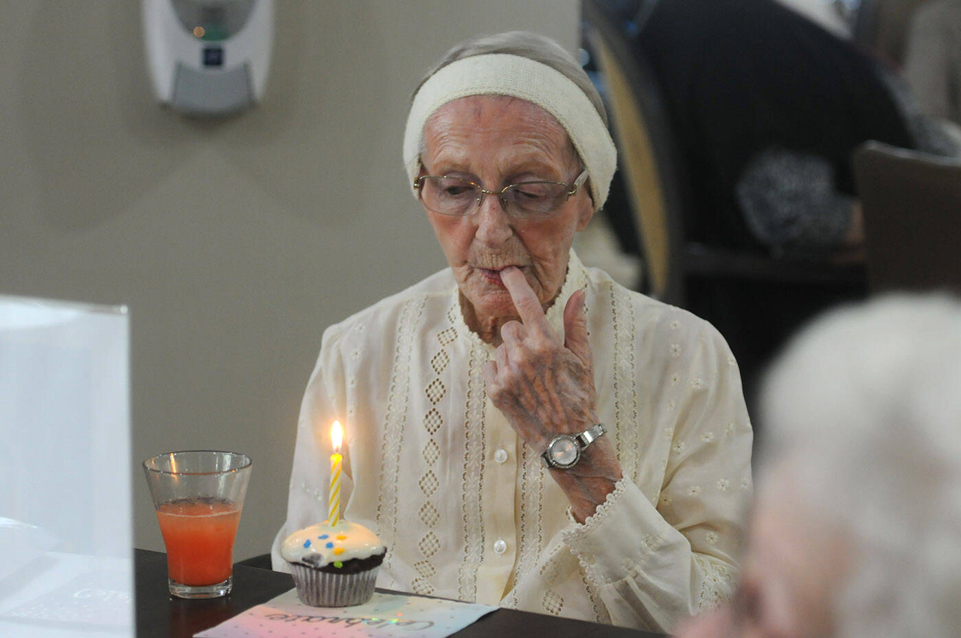 Hedy Sutulov tastes the icing on her cupcake while celebrating her 108th birthday with her friends on Aug. 10, 2022 at Chartwell Birchwood Retirement Residence where she lives. She turned 108 on Aug. 18, 2022. (Jenna Hauck/ Chilliwack Progress)