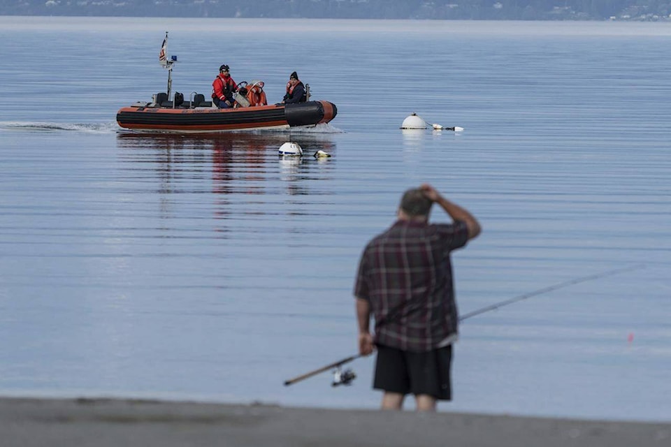 A U.S. Coast Guard vessel searches the area Monday, Sept. 5, 2022, near Freeland, Wash., on Whidbey Island north of Seattle where a chartered floatplane crashed the day before. The plane was carrying 10 people and was en route from Friday Harbor, Wash., to Renton, Wash. (AP Photo/Stephen Brashear)