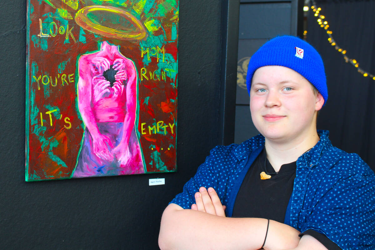 Henri Rocha alongside one of the pieces of art. Rocha was instrumental in the set-up of an art event on June 8, 2022. (Josh Piercey/Revelstoke Review)