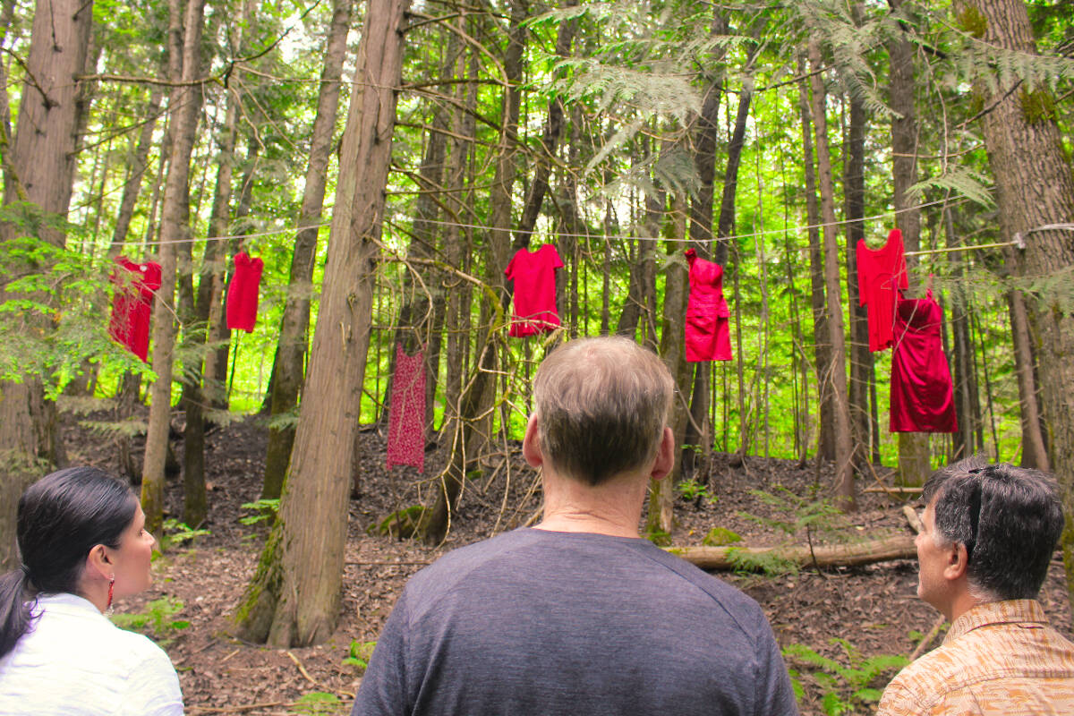 Jessica Stewardson, Mike Hooker, and Todd Hicks of School District 19 viewing the display on National Indigenous Peoples Day, June 21, 2022. (Josh Piercey/Revelstoke Review)