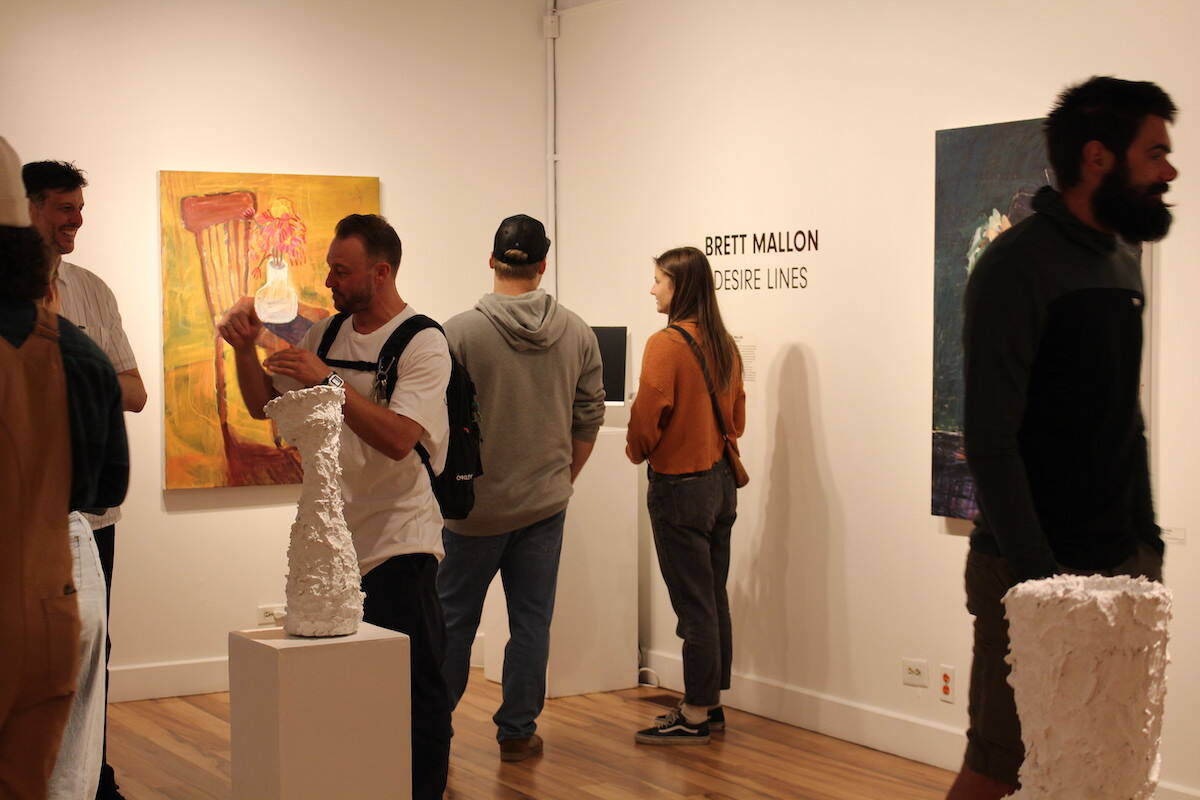 People taking in the latest exhibit in the main gallery at Revelstoke Visual Arts Centre (Zachary Delaney)