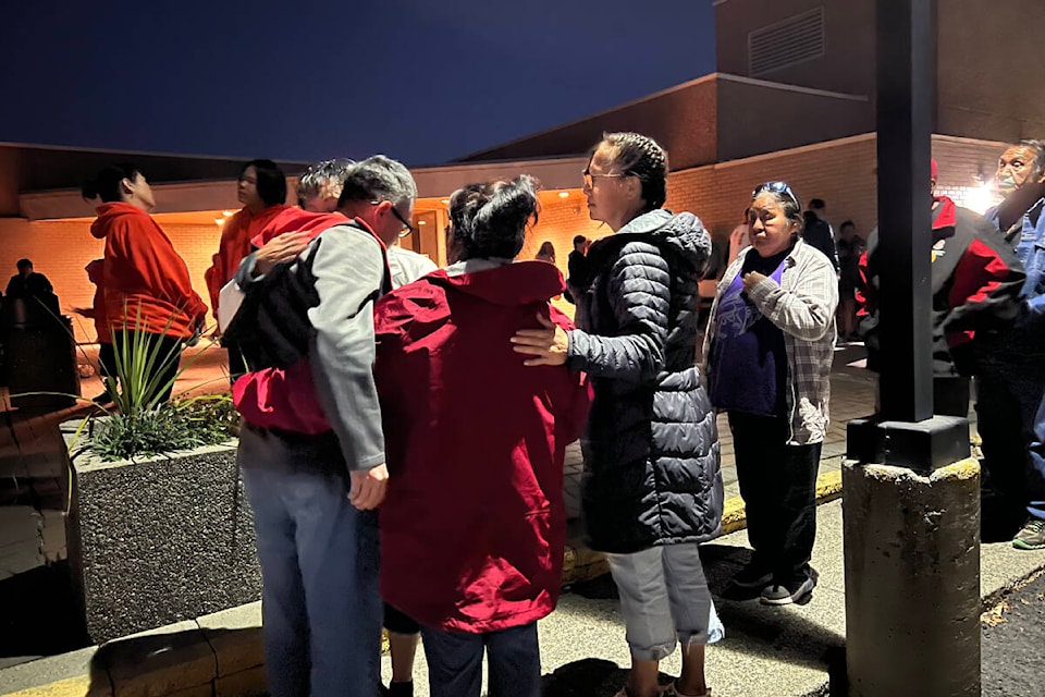 Casey Myers, the father of Surrance Myers, receives support from community members during a candlelight vigil outside the Williams Lake RCMP detachment Sunday evening (Oct. 2). Casey said he was notified Saturday evening that his son died in police cells. (Angie Mindus photo - Williams Lake Tribune)