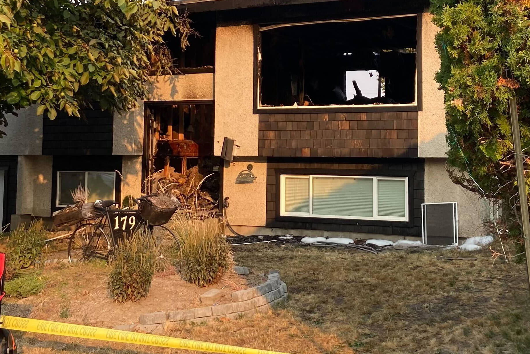 Caution tape and a security guard are at 179 Kirkpatrick Ave. which saw fire rip through the roof and inside Sunday night. (Monique Tamminga Western News)