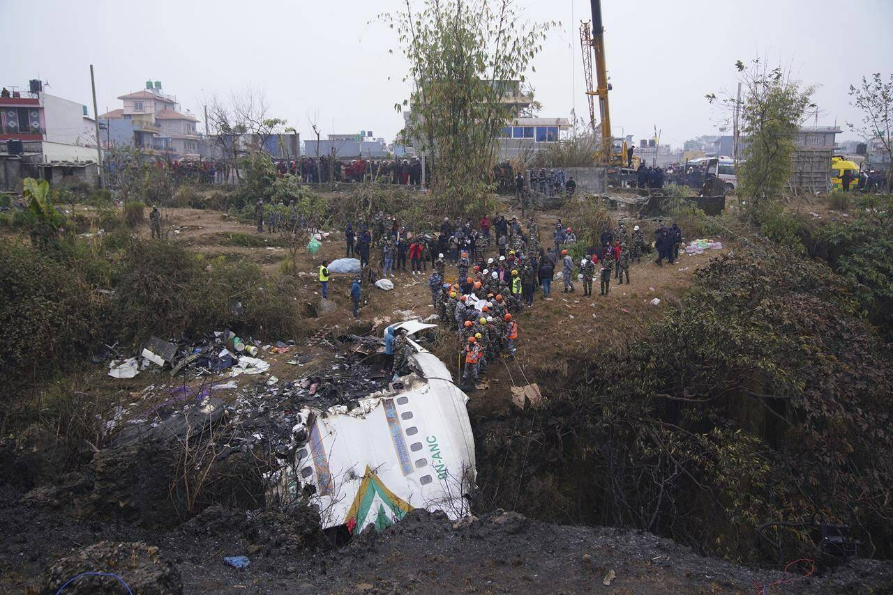 Rescuers scour the crash site in the wreckage of a passenger plane in Pokhara, Nepal, Monday, Jan.16, 2023. Nepal began a national day of mourning Monday as rescue workers resumed the search for six missing people a day after a plane to a tourist town crashed into a gorge while attempting to land at a newly opened airport, killing at least 66 of the 72 people aboard in the countrys deadliest airplane accident in three decades. (AP Photo/Yunish Gurung)
