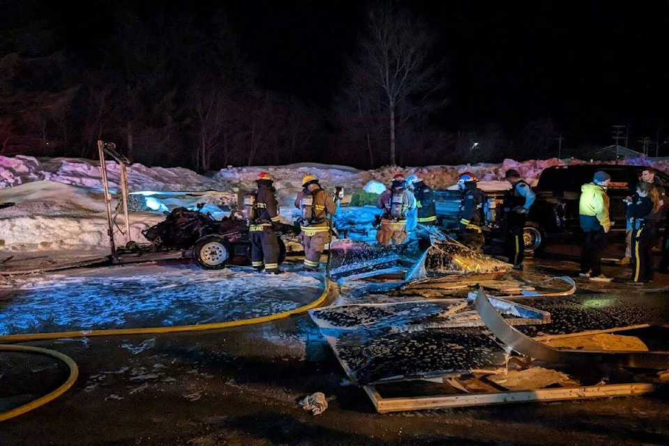 Revelstoke Fire Rescue hosing down the exploded trailer in the Sandman Parking lot in Revelstoke. (Josh Piercey/Revelstoke Review)