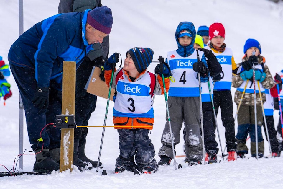 Alan Mason, long time starter for local races, giving last minute encouragement to a young skier. (Photo by Maja Swannie Jacob, Revelstoke Nordic)