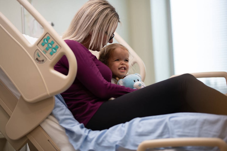 Ava Secuur sits with her mother Shannon in her hospital bed at the BC Children’s Hospital in Vancouver. (Courtesy of BC Children’s Hospital Foundation)