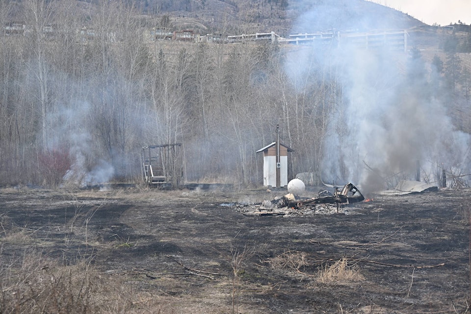 A trailer was burnt down after a brush fire off the KVR Trail near the Penticton Airport. (Brennan Phillips- Western News)