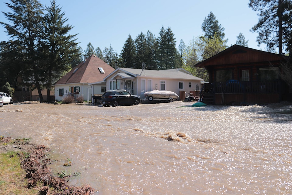 Water has flooded down Falcon Avenue Tuesday, May 2, 2023, prompting an evacuation order. (Brendan Shykora - Morning Star)