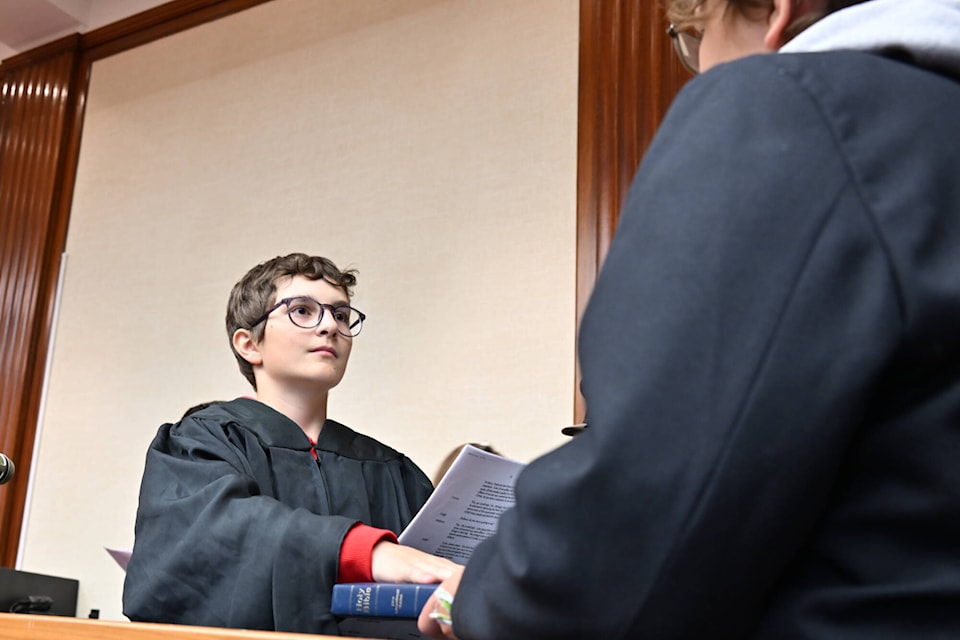 Liam Caldwell swears in “Emperor Palpatine”, Zach Walters, during a mock trial at Law Day in Penticton’s courthouse on May 24. (Brennan Phillips - Western News)