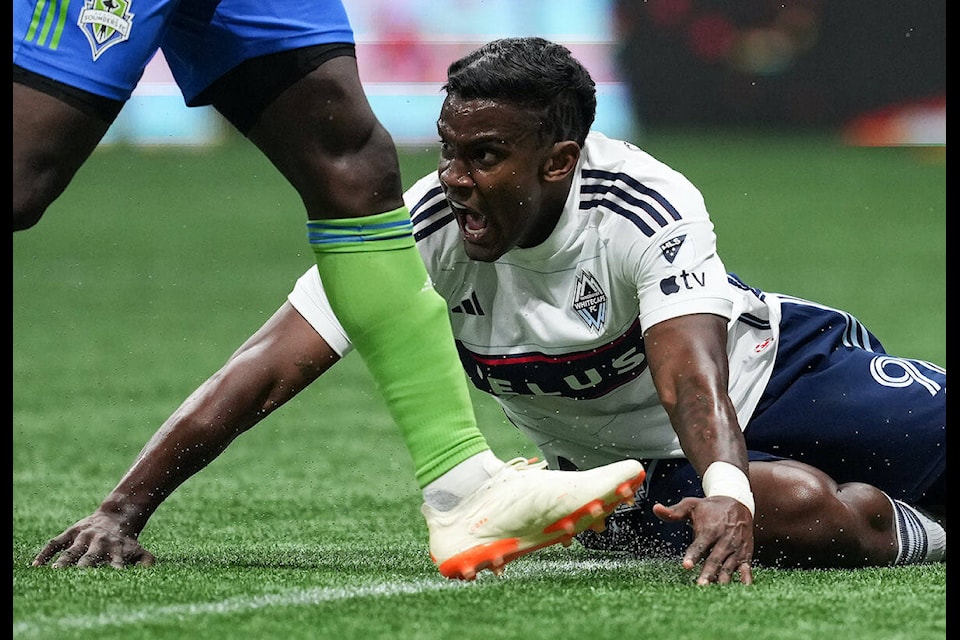 Vancouver Whitecaps’ Sergio Cordova reacts after being pushed off the ball by Seattle Sounders’ Yeimar Gomez during the second half of an MLS soccer match in Vancouver, on Saturday, May 20, 2023. THE CANADIAN PRESS/Darryl Dyck