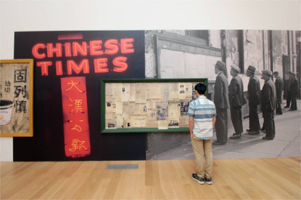 A man looks at an exhibit during the official public opening day of the Chinese Canadian Museum in Vancouver’s Chinatown on Saturday (July 1, 2023). The feature exhibit, Paper Trail, commemorates 100 years since the Chinese Exclusion Act was implemented. It’s the largest collection of the identity cards, with families sharing their ancestors cards. (Lauren Collins)
