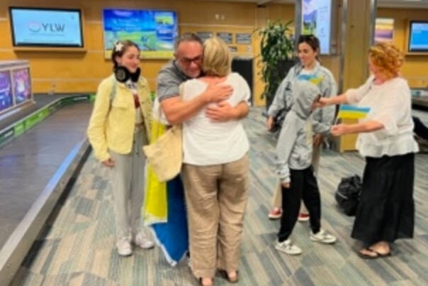 After seven months of trying to get to B.C., a Ukrainian family of four arrive at Penticton Airport on July 4. Left to right: Milena 13, Lasha with Jennifer Martison of UNP (hugging) and Salome in the jean jacket, Amiran, 11, and Tanya Wildman (translator for UNP).(Submitted)