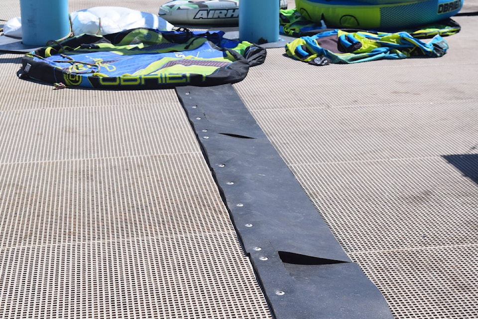 Gaps and cracks are visible in the rubber mats that cover gaps in the docks at Lake Okanagan Resort where Okanagan Lake Boat Rentals operates. (Brittany Webster/Capital News)