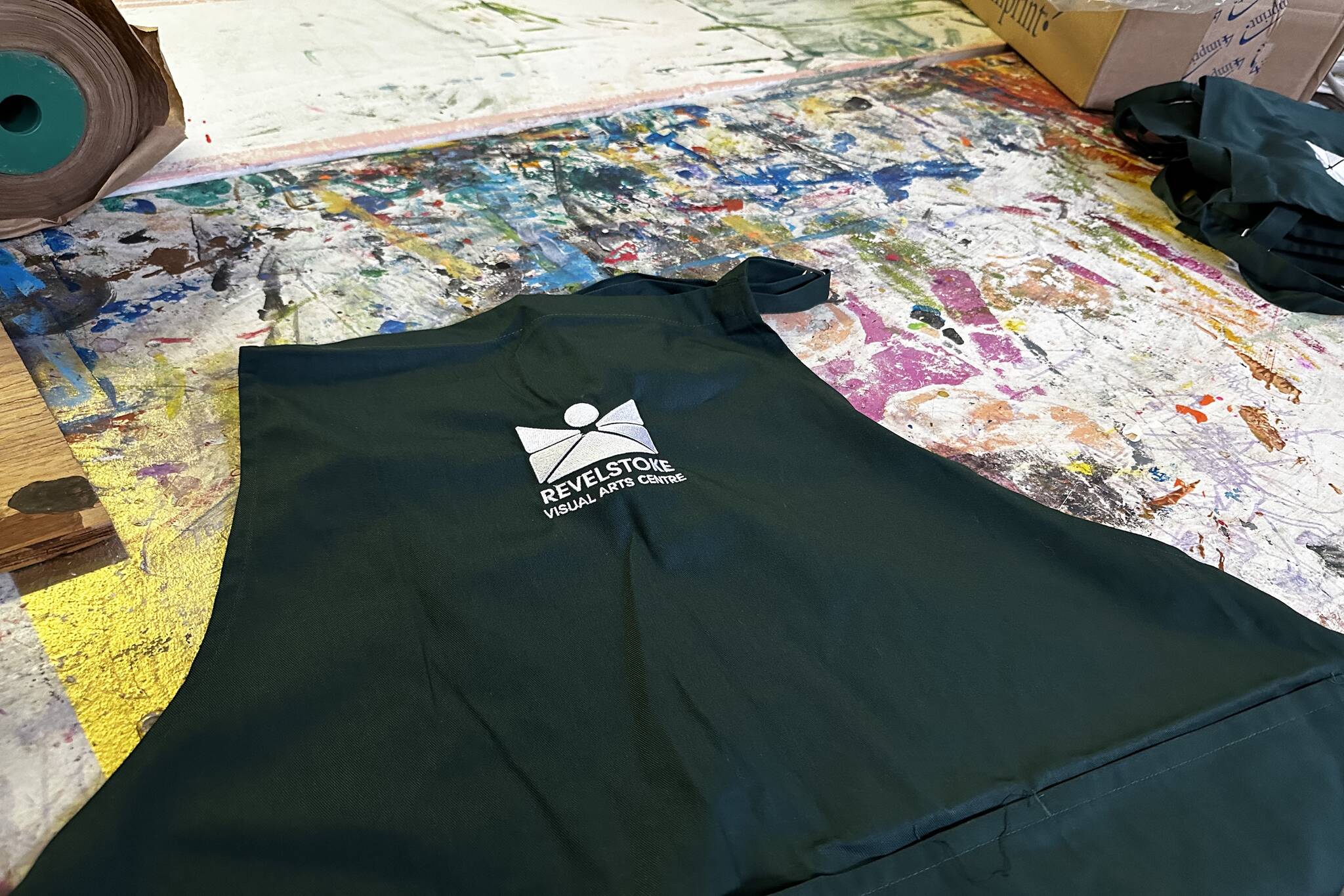 The aprons help showcase the Revelstoke Visual Arts Centre brand while also serving the practical purpose of keeping the centres students clean. (Zachary Delaney/Revelstoke Review)