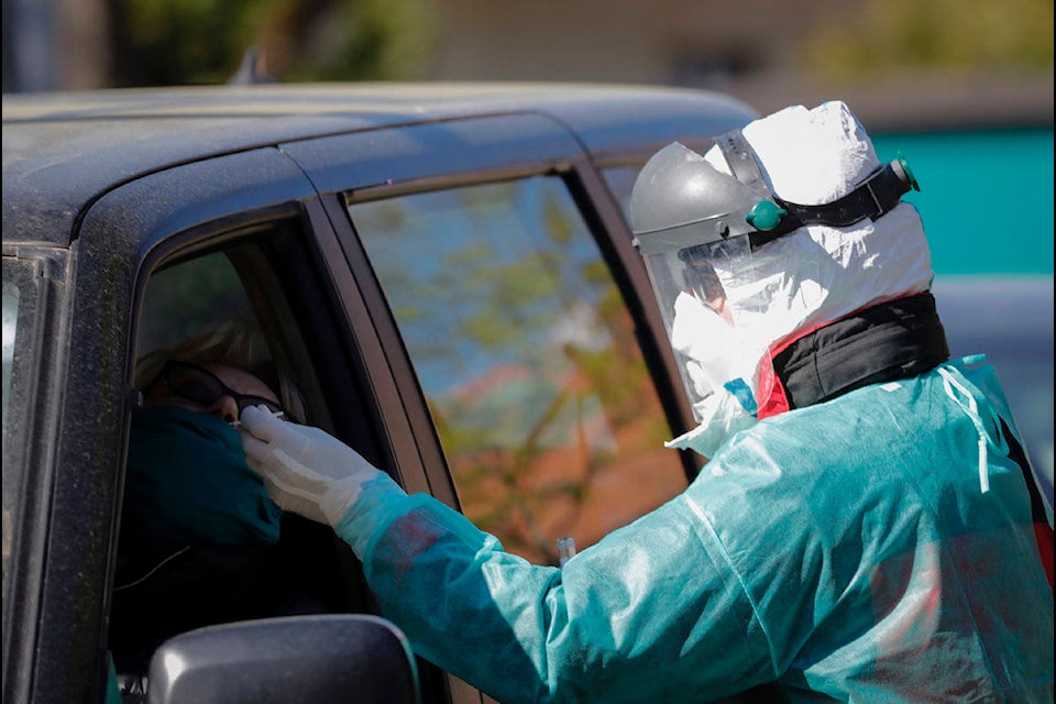 A driver gets tested for COVID-19 at a drive-through point in Zagreb, Croatia, Wednesday, April 1, 2020. (AP Photo/Darko Bandic)