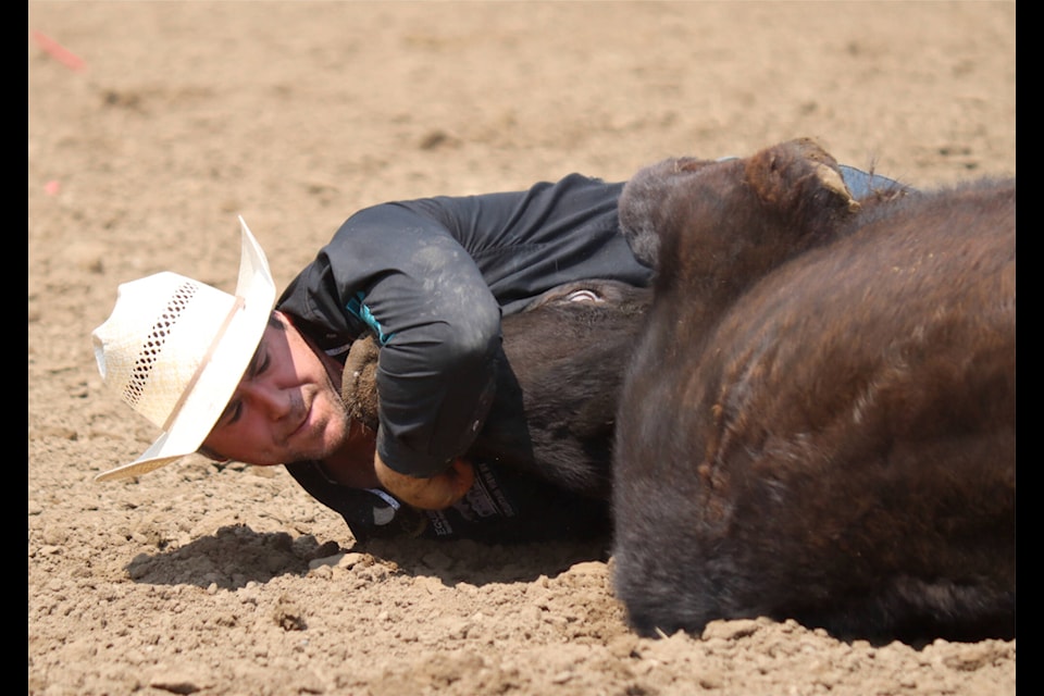 Morgan Grant of Didsbury, Alta. has a time of 14.0 in the steer wrestling. (Emily Jaycox/Ponoka News)