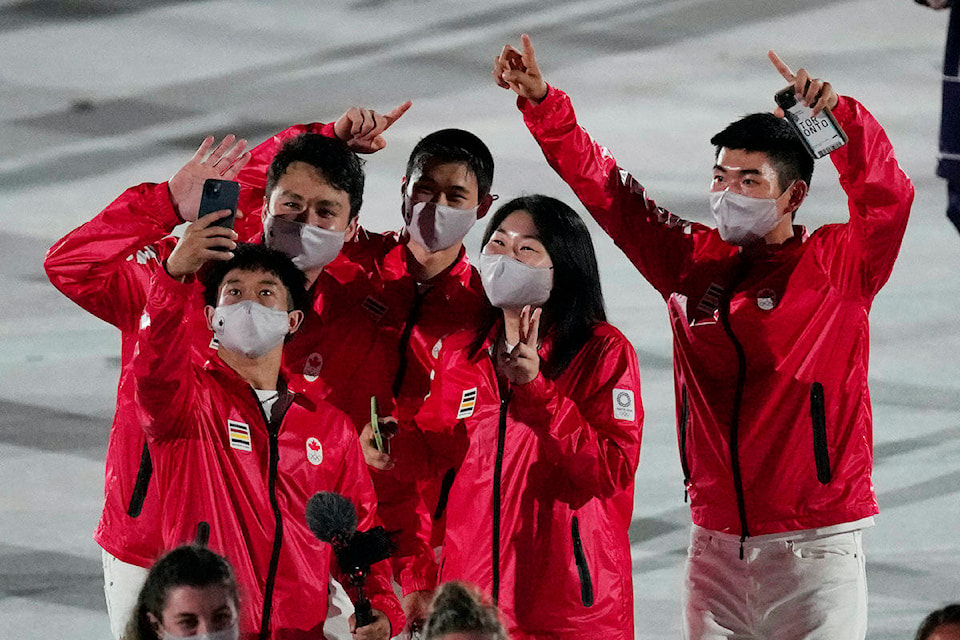 Athletes from Canada walk during the opening ceremony in the Olympic Stadium at the 2020 Summer Olympics, Friday, July 23, 2021, in Tokyo, Japan. (AP Photo/David J. Phillip) Athletes from Canada walk during the opening ceremony in the Olympic Stadium at the 2020 Summer Olympics, Friday, July 23, 2021, in Tokyo, Japan. (AP Photo/David J. Phillip)