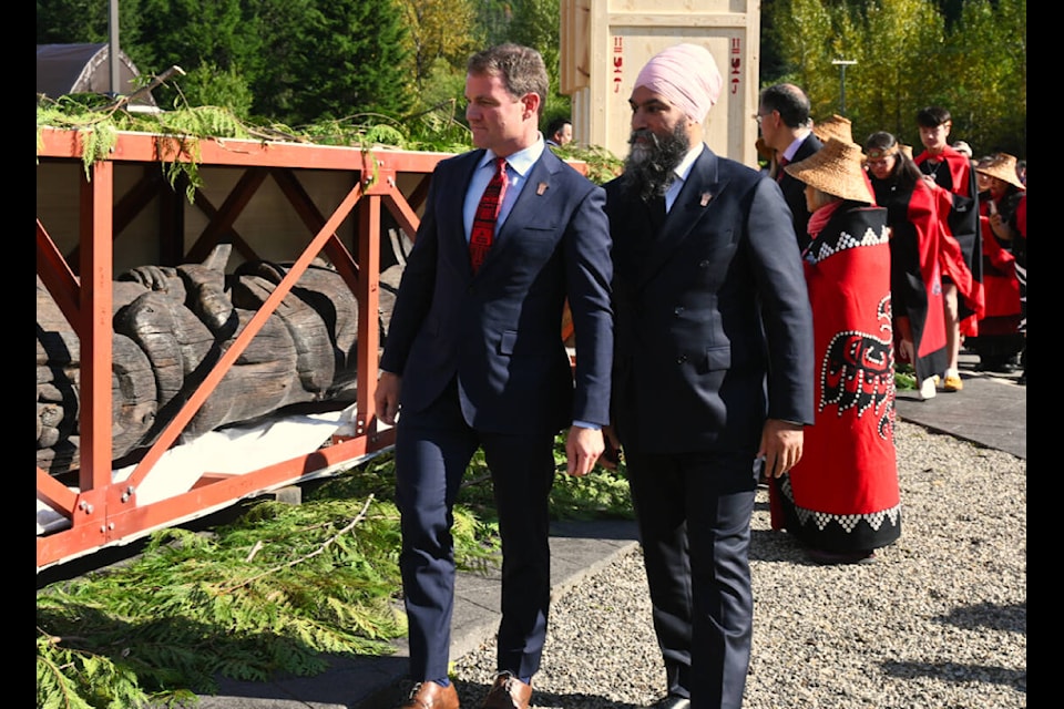 NDP leader Jagmeet Singh, right, with Skeena-Bulkley Valley MP Taylor Bachrach view the pole during the celebration. (Seth Forward/Northern View)