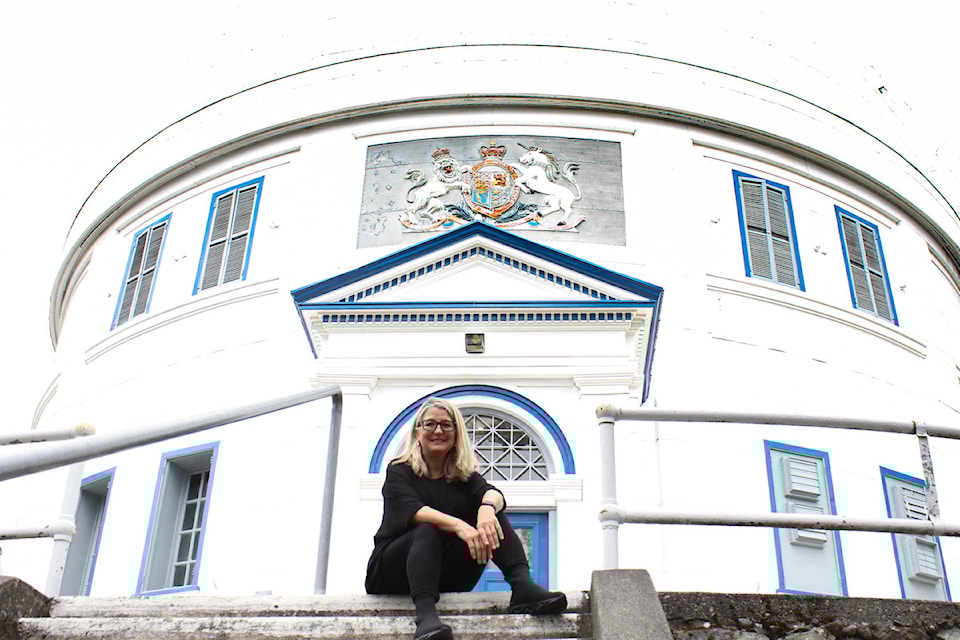 NDP candidate for Saanich South, Lana Popham, sits on the steps outside the Dominion Observatory.