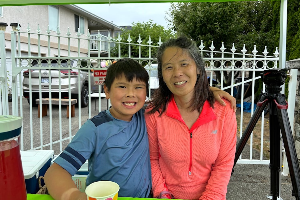 Anders Yee and his mother Susanna Yee at the lemonade stand on Monday, Aug. 12.