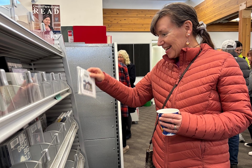 Anne Parker, who worked as a children’s librarian at Nellie McClung for over a decade, spotting an Indigo Girls album in the library's CD rack.