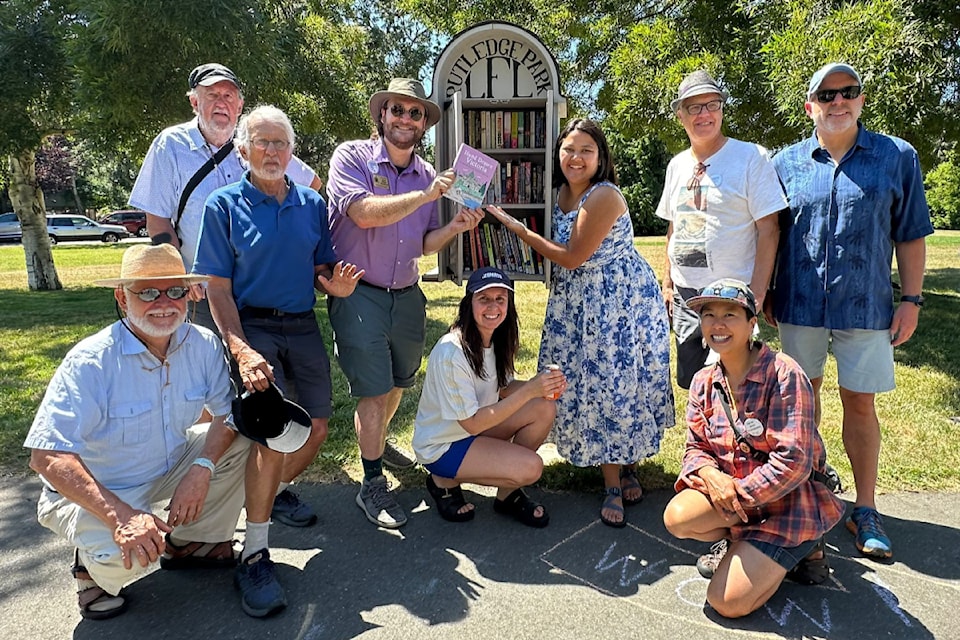 Greater Victoria Placemaking board and volunteers deliver the 100,000th book to the little free library in Rutledge Park. 