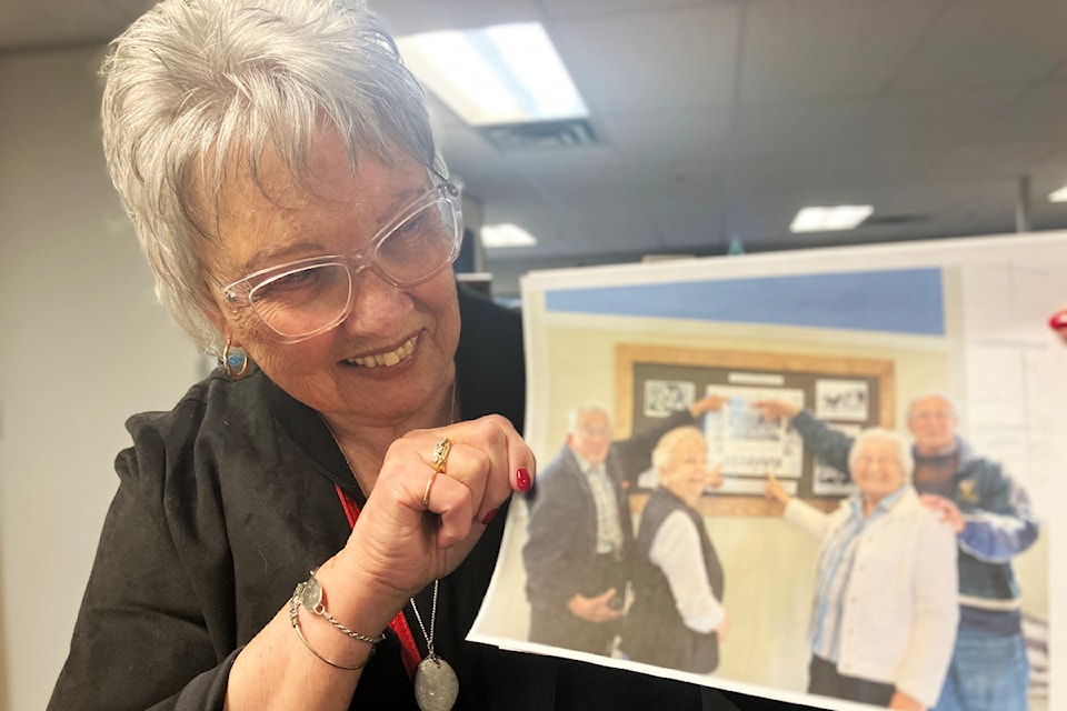 Barbara Handysides shows a photo of a historic display dedicated to the one-room school house in the Royal Oak neighbourhood of Saanich.