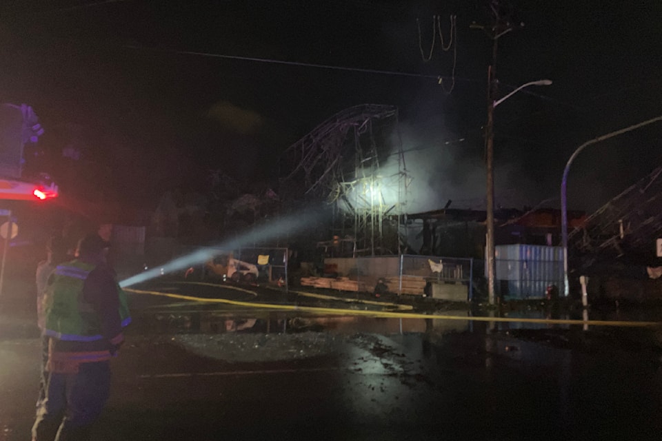 Saanich fire crews survey the damage done by a hot fire buffeted by high winds in the early hours of Nov. 20. 