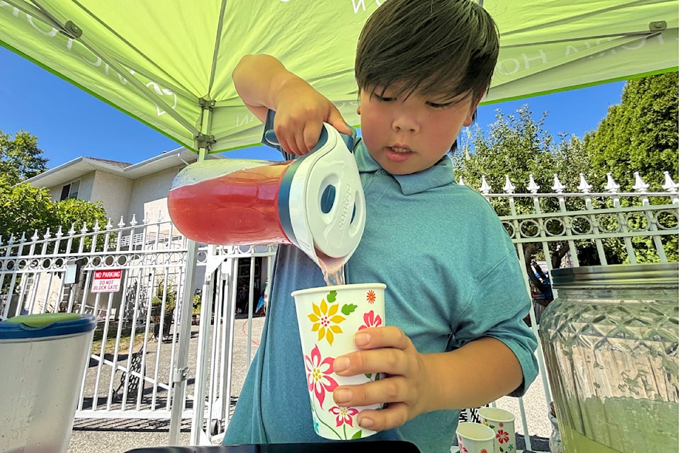 Anders Yee pours pink lemonade at his third annual lemonade stand on Aug. 11.