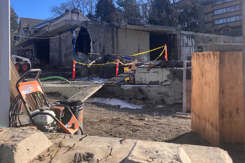 Crews work to clean up the site of a November 2024 blaze that razed a building under construction at the corner of Quadra and Palmer streets. 