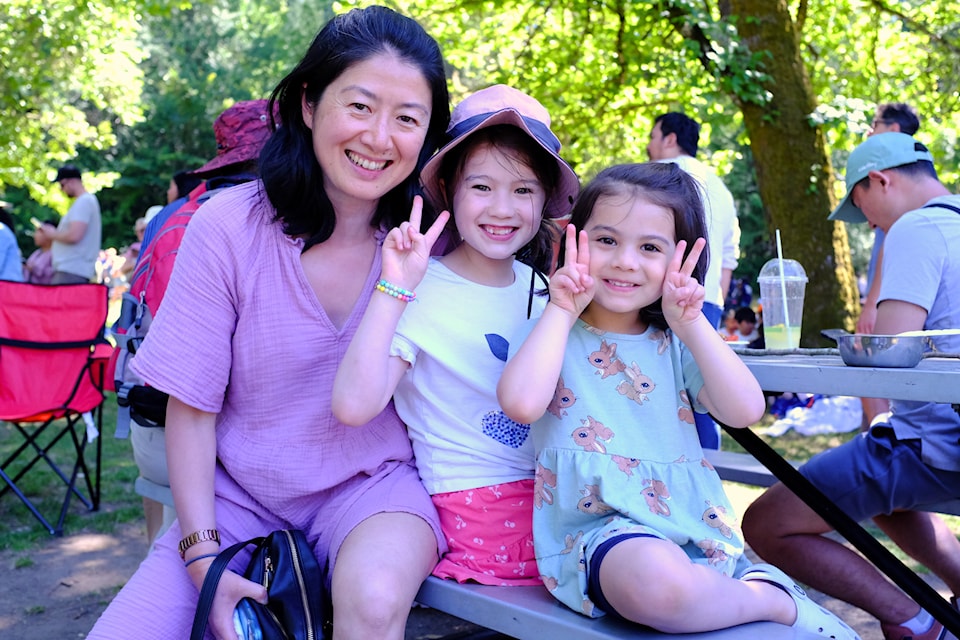 Mother Hong Gou, with daughters Clara and Issa from Boston, attended their first-ever Strawberry Festival together.