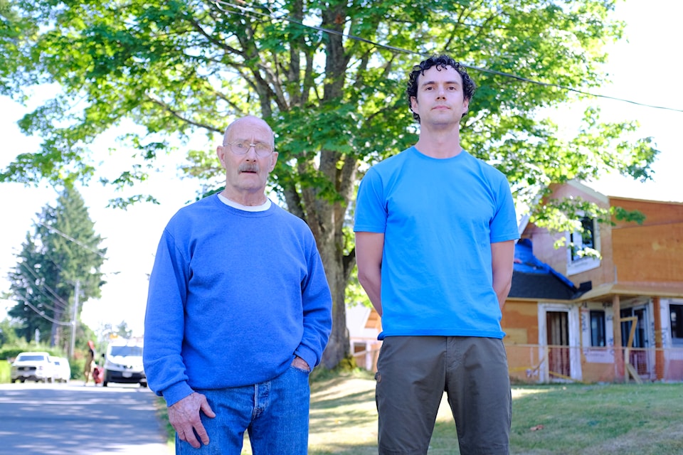 Neighbours Steve Lush (right) and Ross Ramage stand in front of the 100-year-old bigleaf maple at 5032 Wesley Rd. in Cordova Bay.