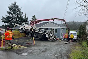 Soggy conditions topple concrete truck over Saanich home