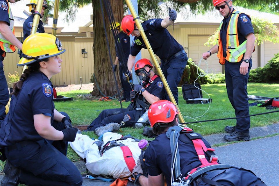 Saanich staff from the Occupational Health and Safety and Public Works divisions, Saanich Police Department and Saanich Fire Services work together to respond to a confined space rescue during an emergency drill on May 8. 