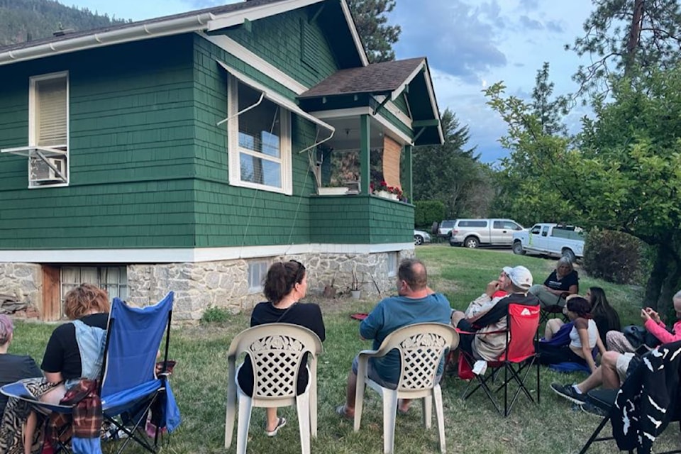 Volunteers ready to start counting bats that will emerge from the gable vent.  These conservation-minded homeowners manage their house to safely allow the bat colony to live in the attic.  