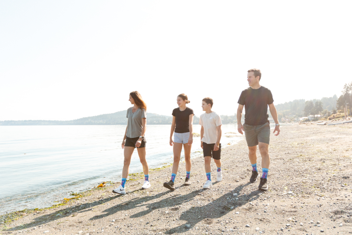 The Millar family walks the beach in Saanich bearing Eamonn's latest design, an axolotl exploring the enchanted deep.