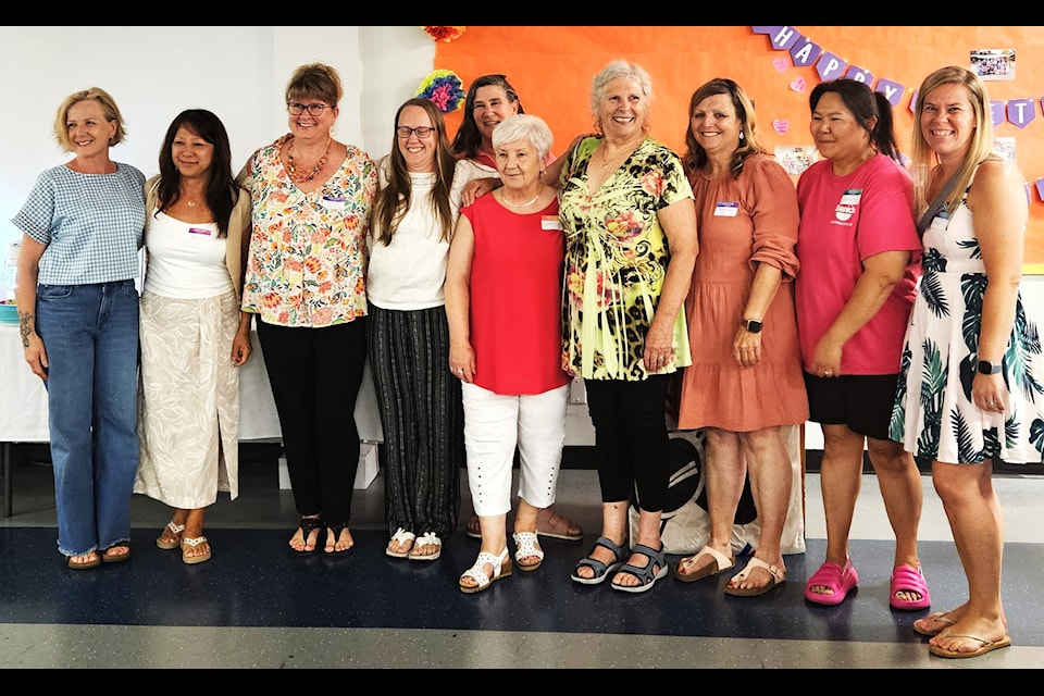 Hundreds turned out to celebrate Diana Wigen's (fourth from right) retirement as a preschool leader at Commonwealth Place